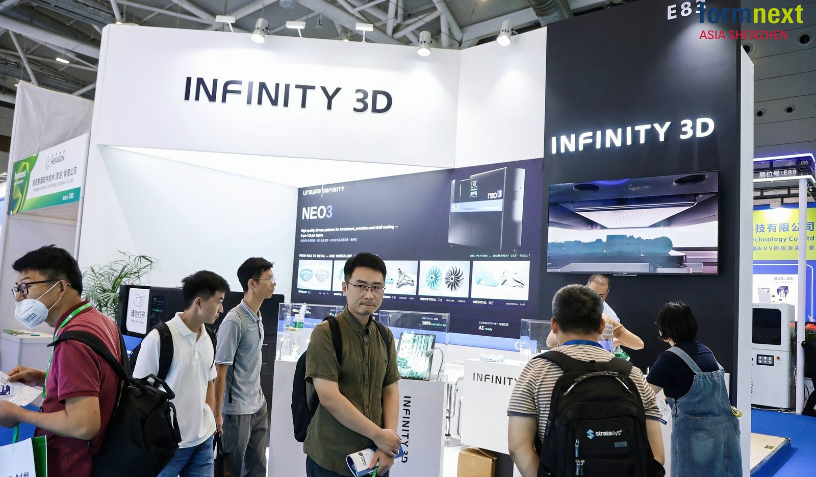 Visitors examining printed wax patterns at the Infinity 3D stand